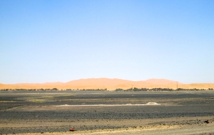The dunes of Erg Chebbi loom and beckon from the distance.
